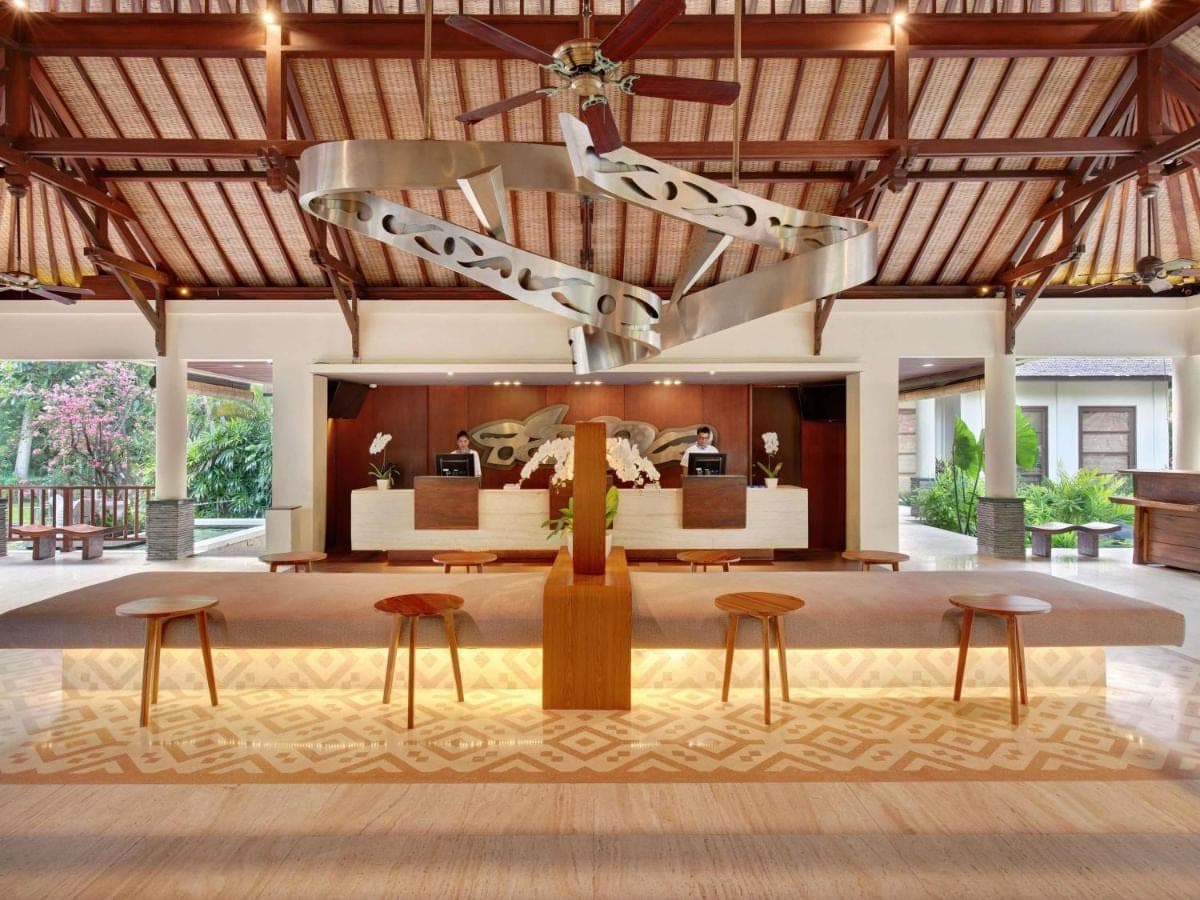 a lobby with two tables and two stools at Novotel Bali Nusa Dua in Nusa Dua