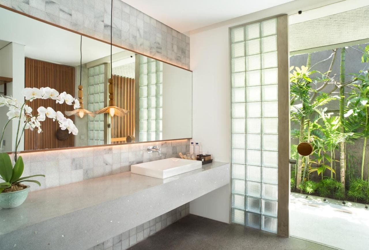 a bathroom with a sink and a mirror at Atelier TE Designer Guesthouse in Sanur