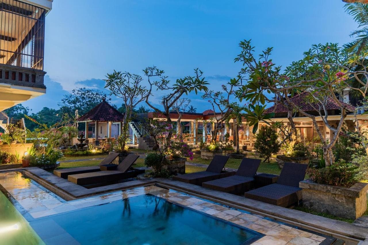 a courtyard with a swimming pool in a villa at Pondok Wana Ubud in Ubud