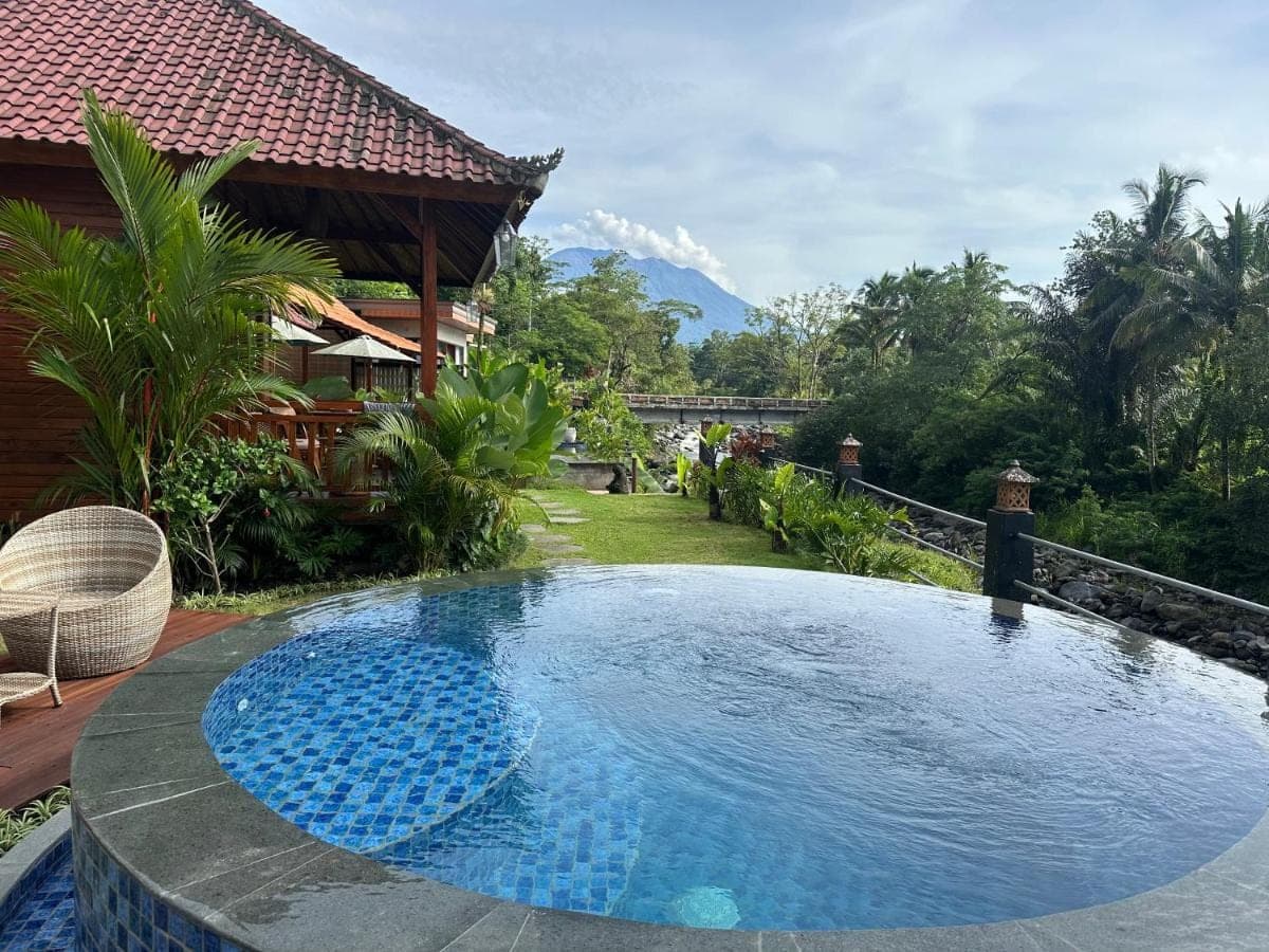 a large swimming pool in a yard with a house at Uma Swari Villa Sidemen in Sidemen