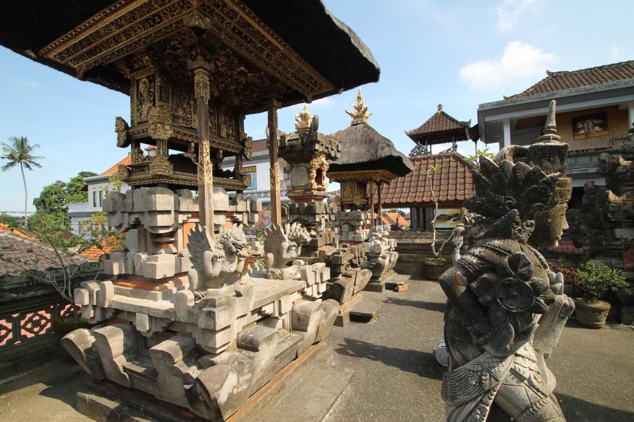 a group of statues in front of a building at Yuni's House in Ubud