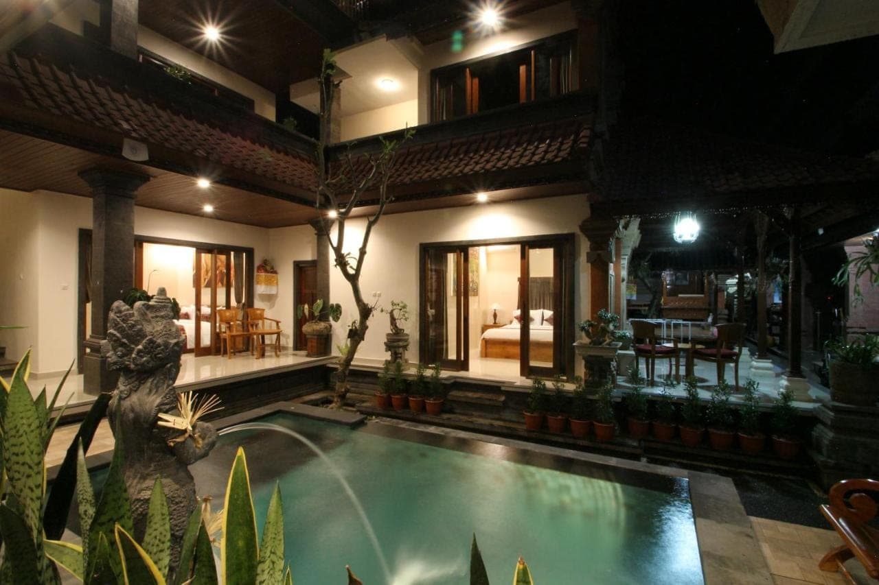 a house with a swimming pool in front of it at Yuni's House in Ubud