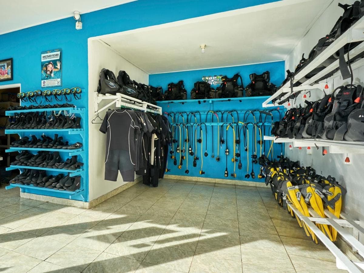 a dressing room with blue walls and racks of shoes at Villa Mimpi Manis infinity pool&amp;180\u00b0Ocean view in Amed