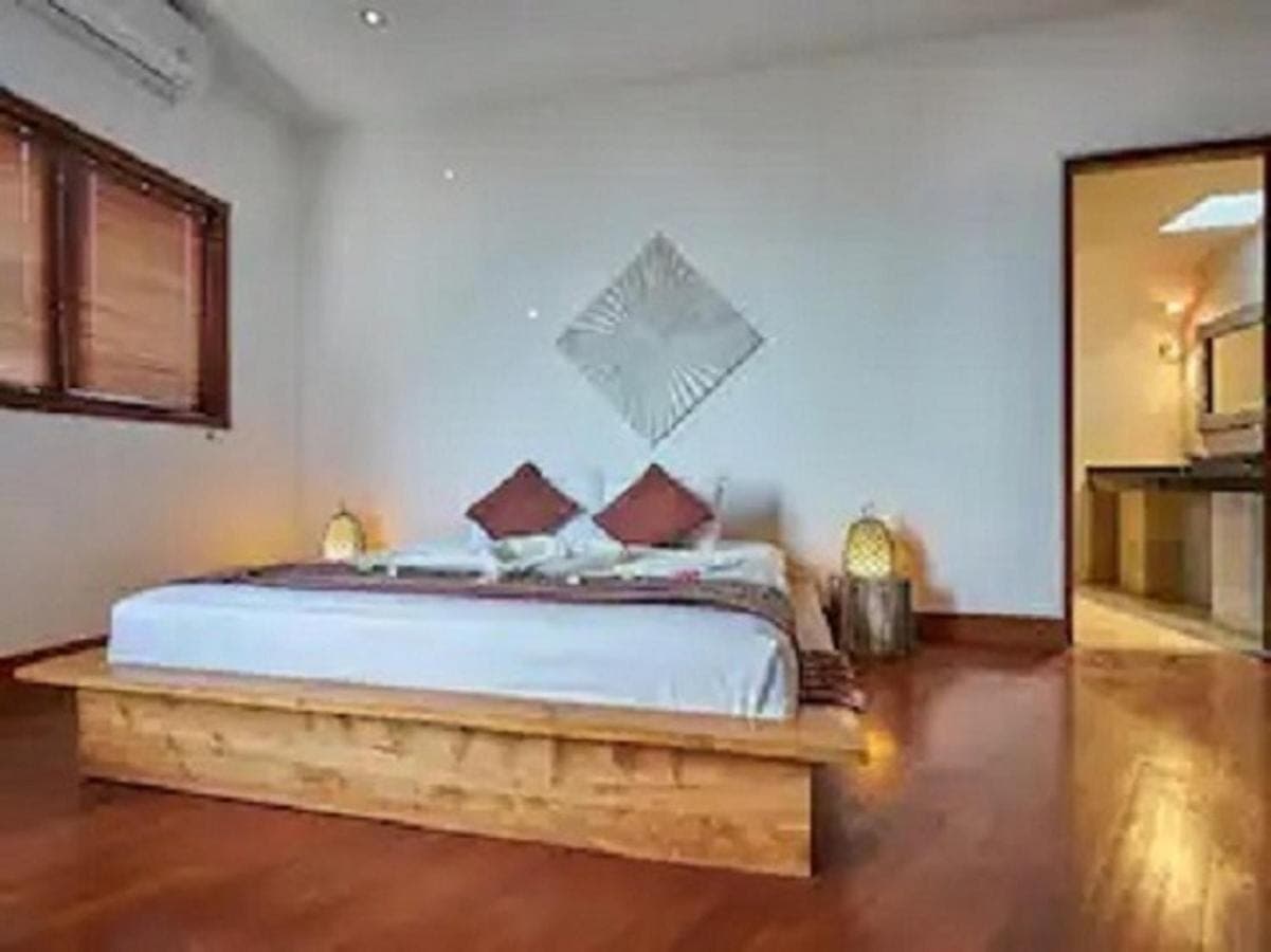 a bedroom with a large bed in a room at Villa Mimpi Manis infinity pool&amp;180\u00b0Ocean view in Amed