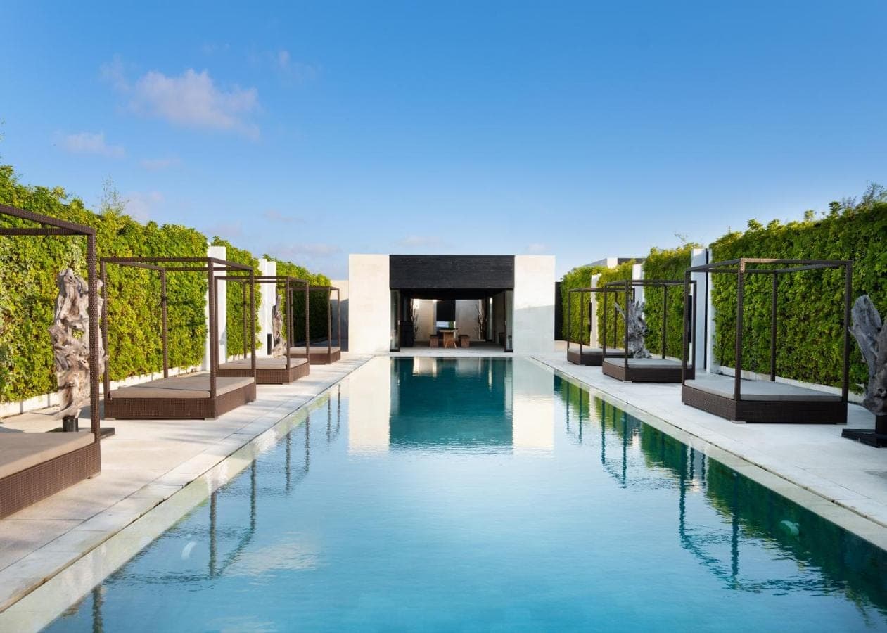 a swimming pool in a villa with vines at eqUILIBRIA Seminyak in Seminyak