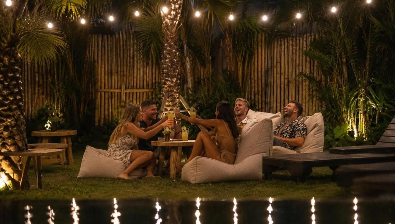 a group of people sitting on a couch at a party at White Penny Bali in Seminyak