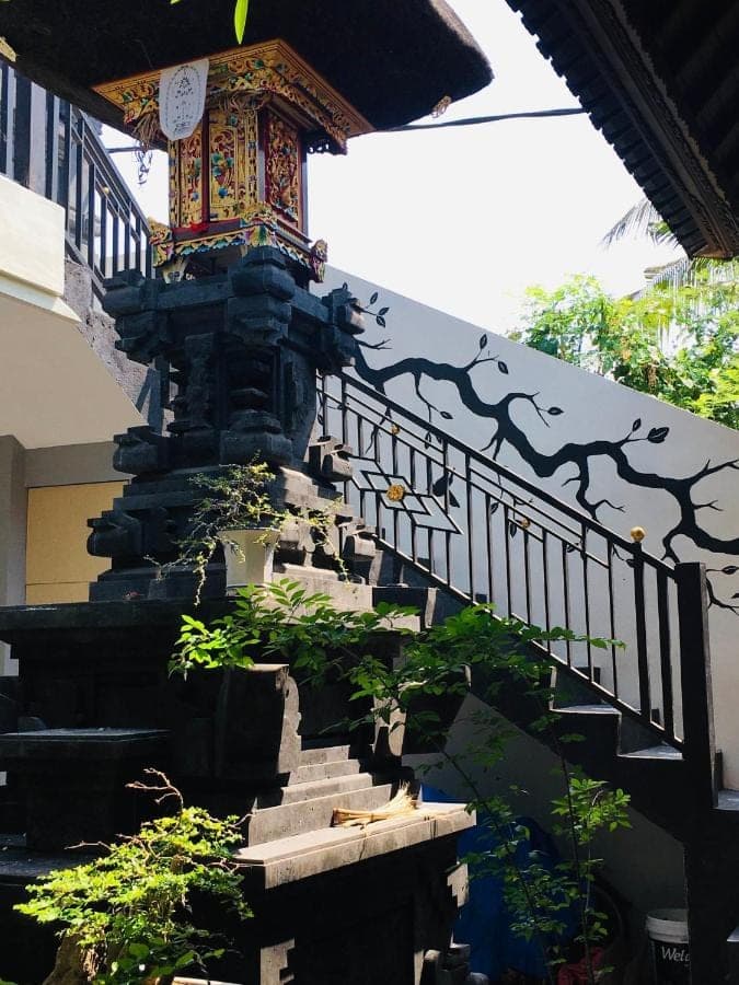 a staircase leading to a building with a balcony at Nadialit in Seminyak