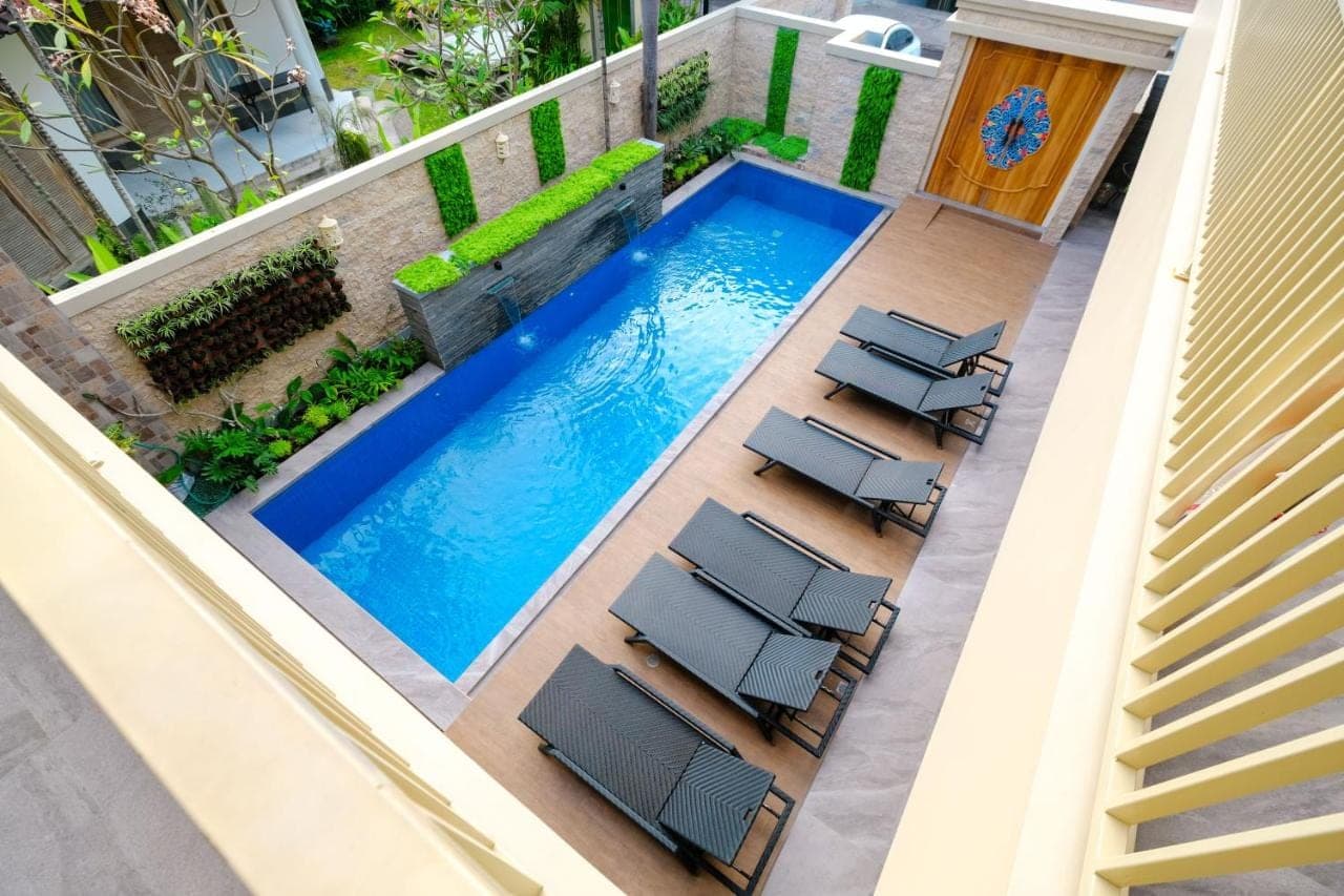 an image of a swimming pool on a balcony with chairs at Kris Residence Sanur in Sanur
