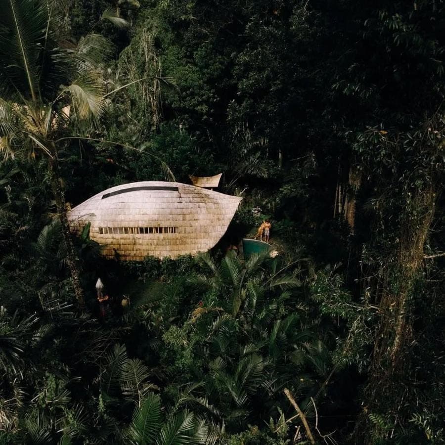 a wooden boat sitting in the forest at Bamboo House - Ecobreeze in Sidemen