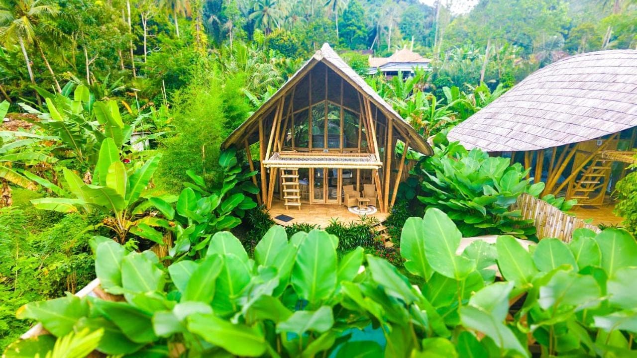 an aerial view of a small house in a forest at Bamboo House - Ecobreeze in Sidemen
