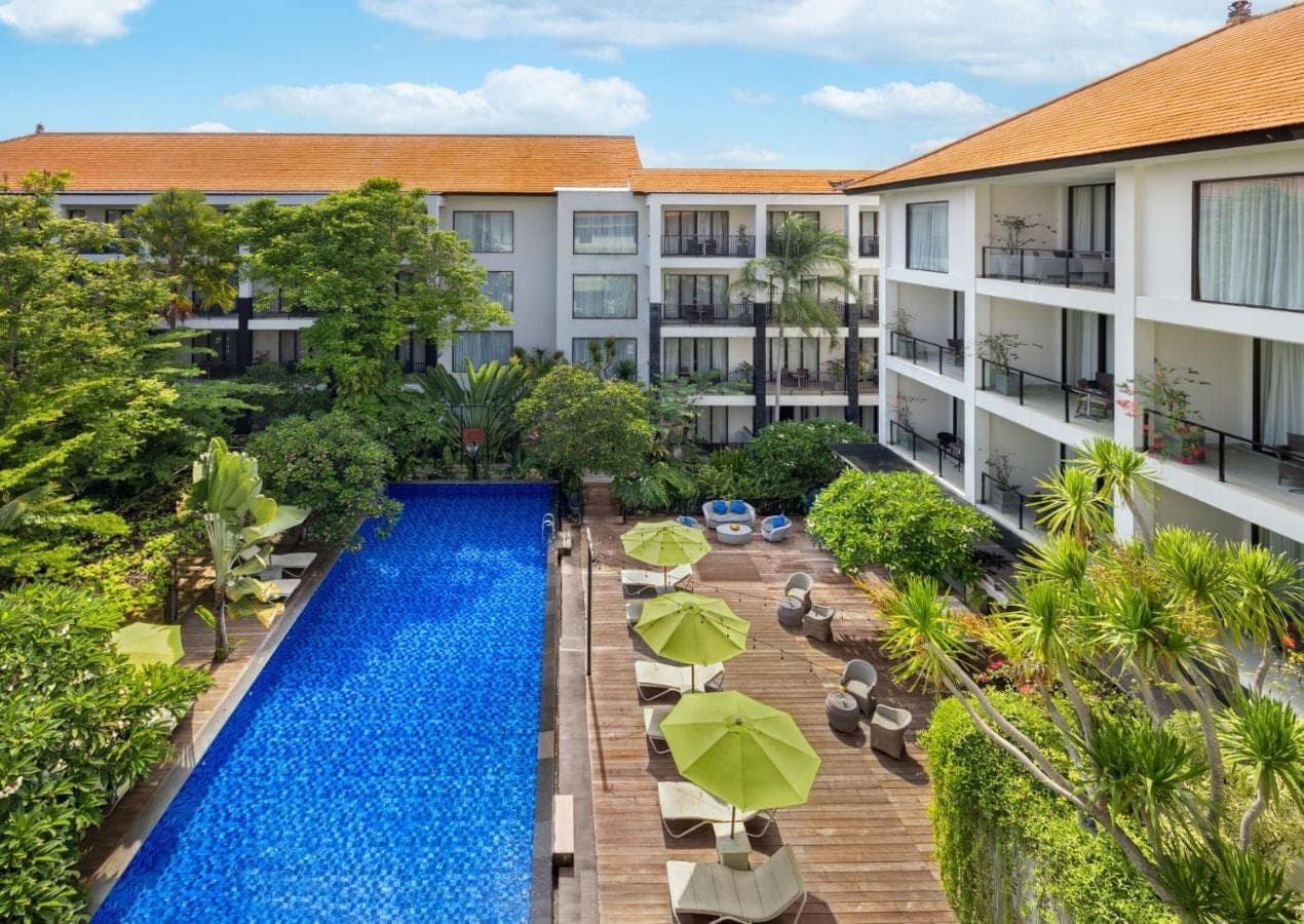 an aerial view of a hotel with a swimming pool at Taksu Sanur Hotel in Sanur