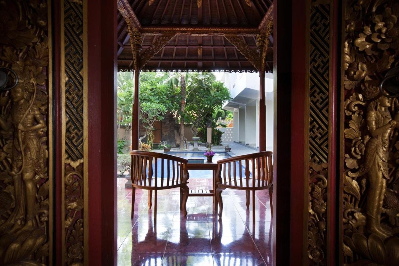 a dining room with a table and two chairs at Nesa Sanur Bali in Sanur