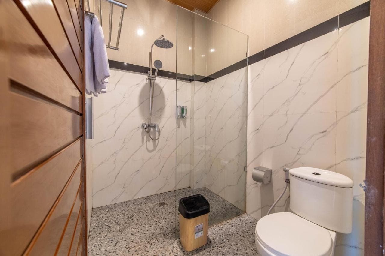 a bathroom with a toilet and a shower at Skyline Sanur by Manara in Sanur
