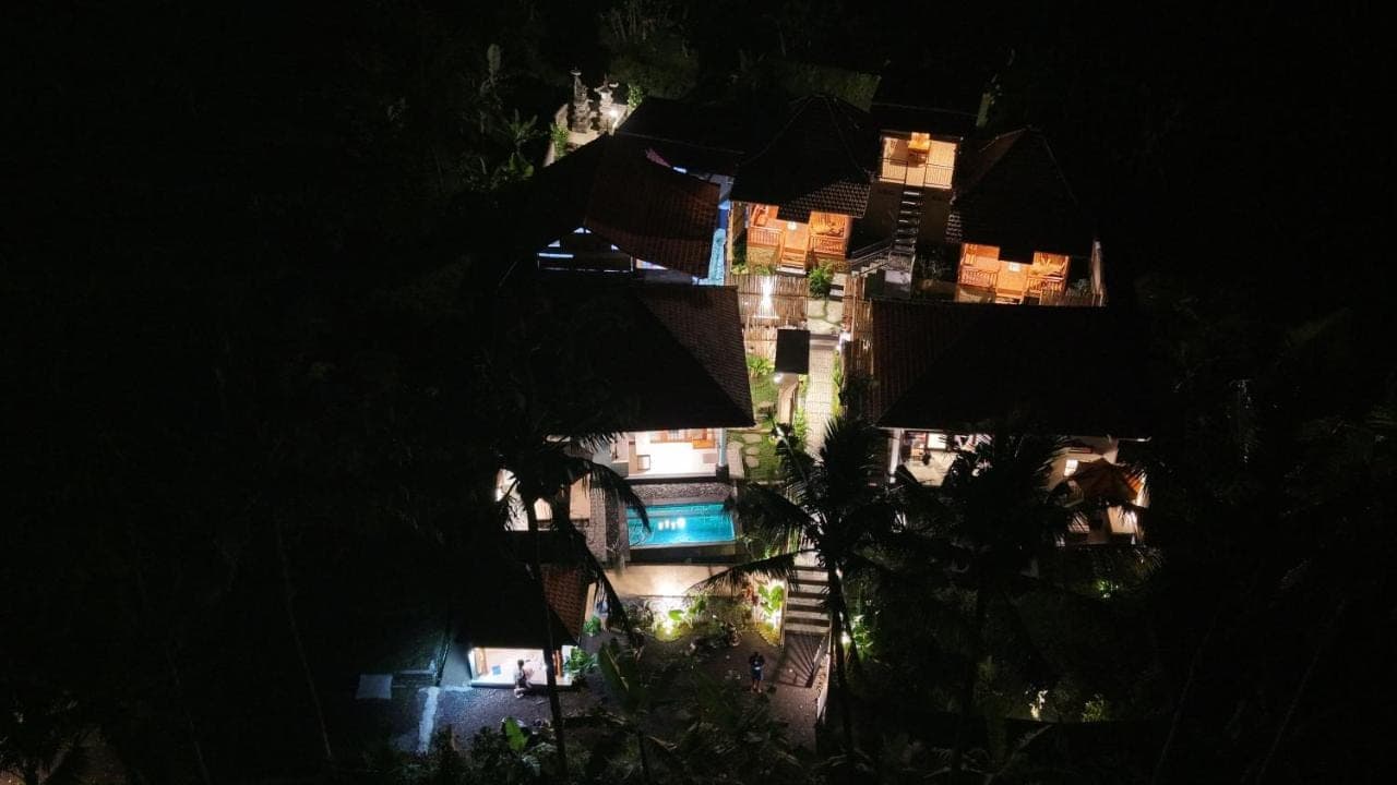an overhead view of a house at night with lights at Dewi Teduh Villa in Sidemen