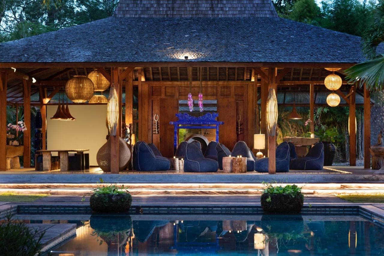 a house with a pool in front of it at Blue Karma Village in Seminyak