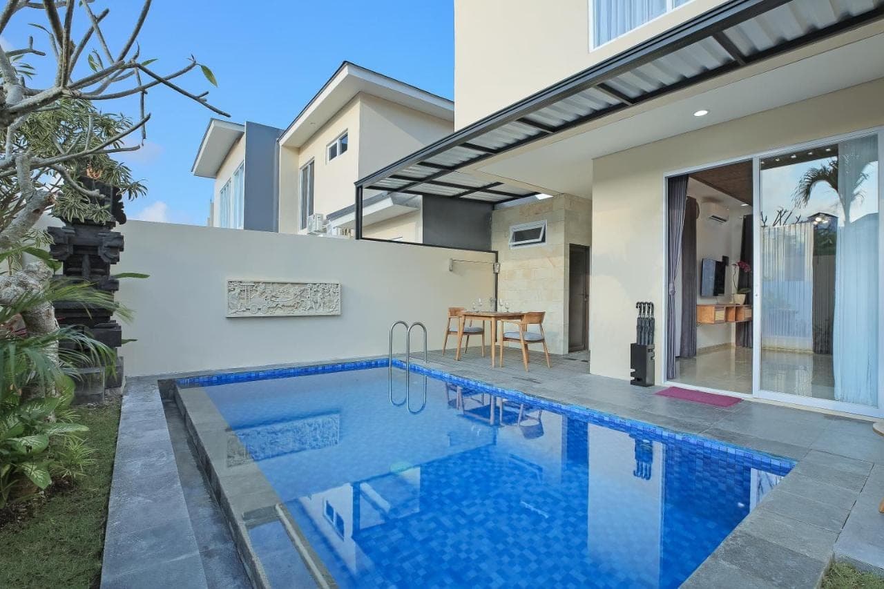 a swimming pool in the backyard of a house at Opin Villa in Nusa Dua
