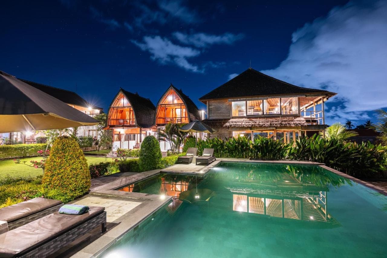 an image of a house with a swimming pool at night at Canggu Wooden Green Paradise in Canggu