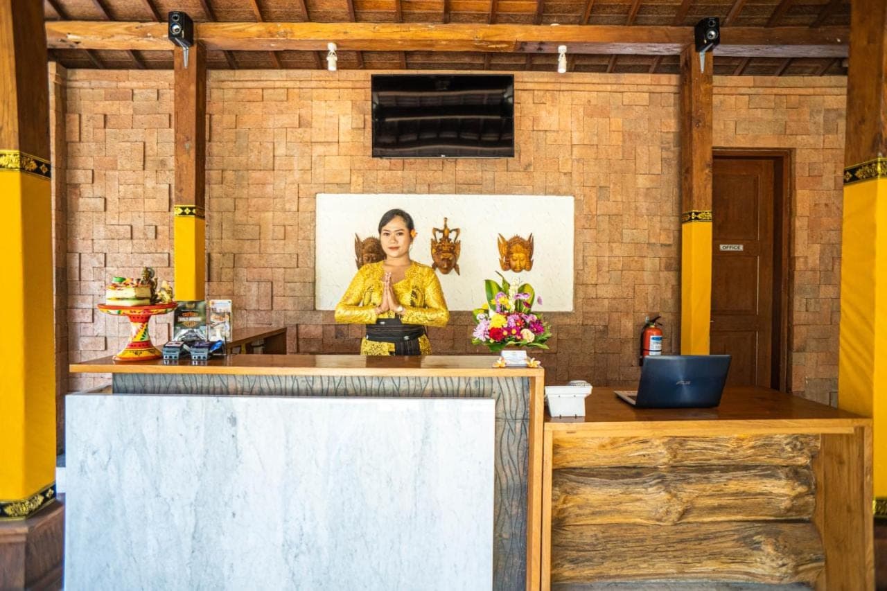 a counter with a picture of a woman on a brick wall at djabu Echo Beach Hotel in Canggu
