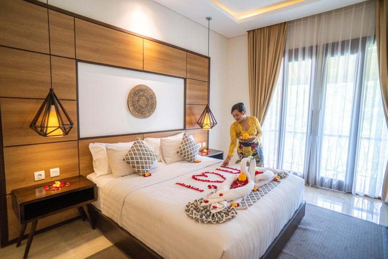 a woman standing on a bed in a hotel room at djabu Echo Beach Hotel in Canggu