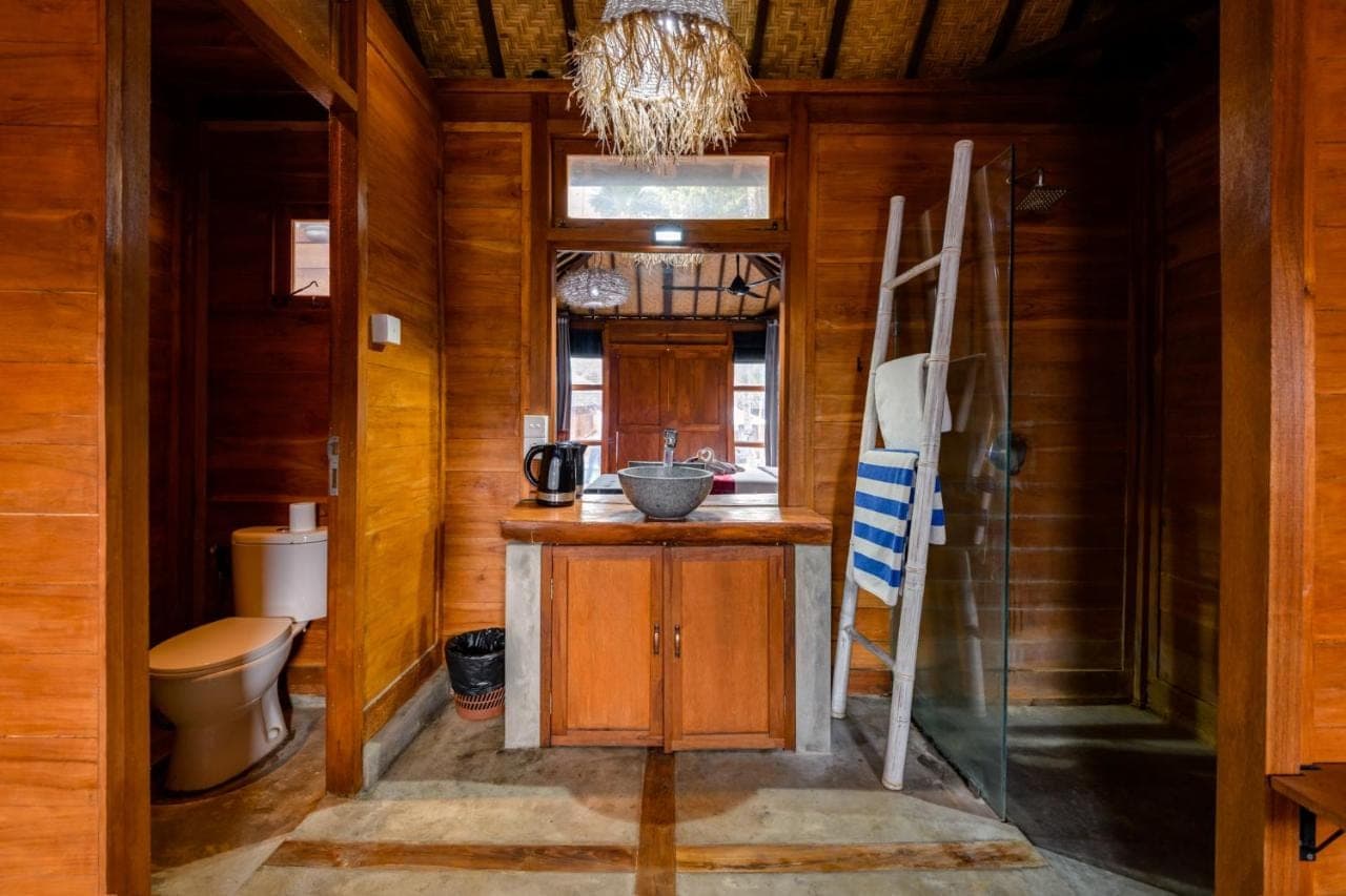 a bathroom with a sink and a toilet at Turtle Villas, Canggu by Manara in Canggu