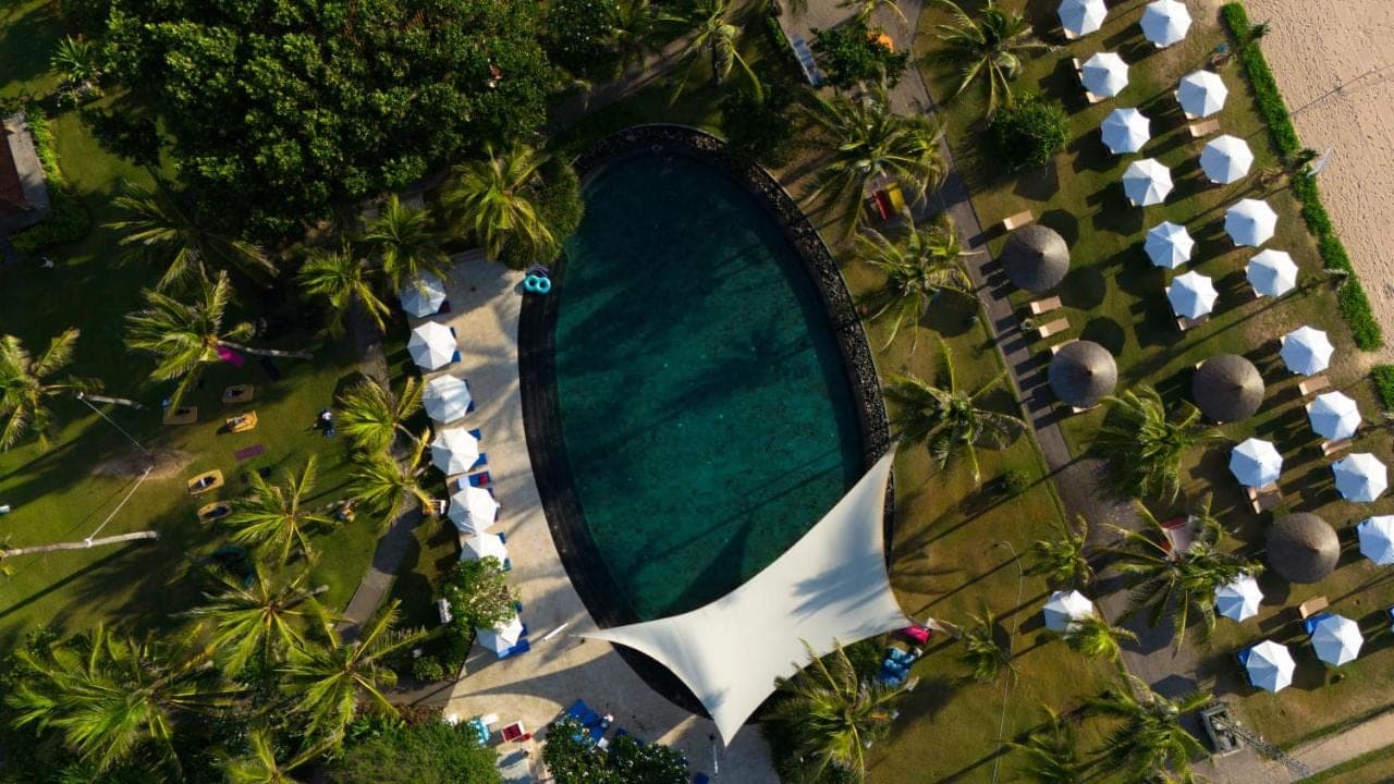 an overhead view of a swimming pool with palm trees at Ayodya Resort Bali in Nusa Dua