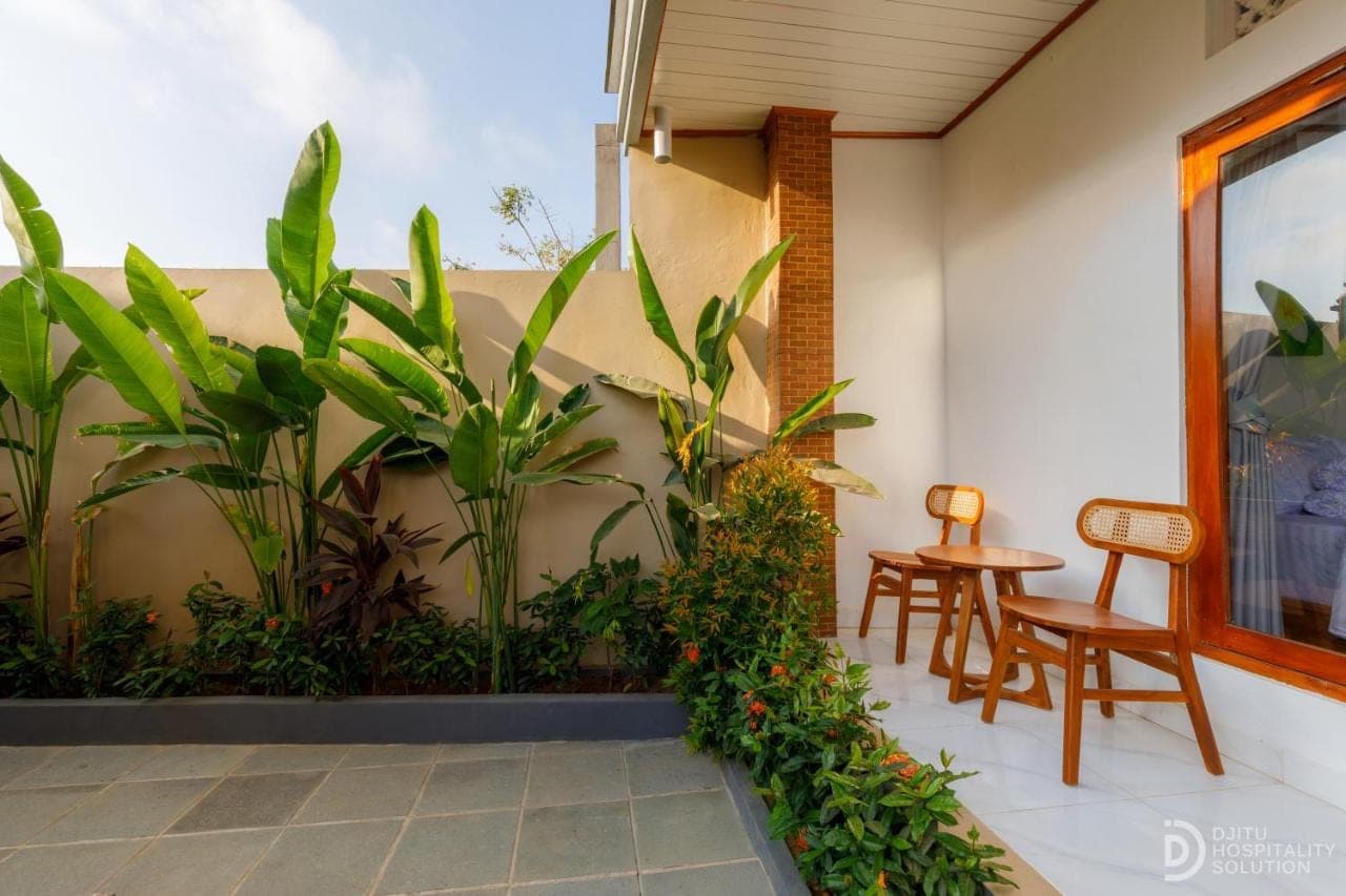 a patio with two chairs and a table at Pradja Homestay in Nusa Dua