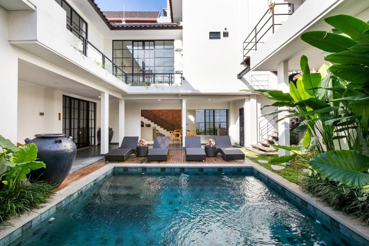 an indoor pool in a villa with a house at Beach8 Canggu by Kerta Living in Canggu