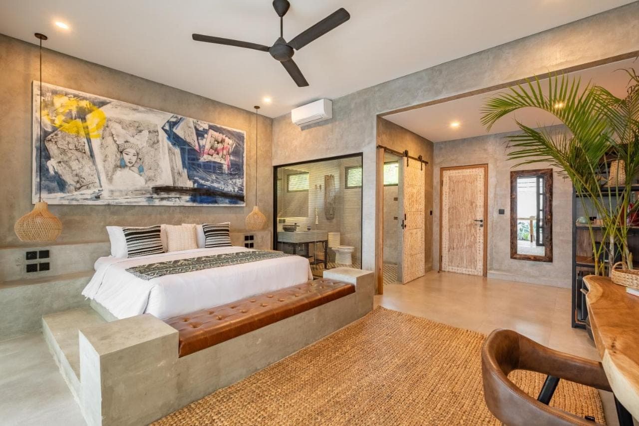 a bedroom with a bed and a ceiling fan at Ubud Lila Concept in Ubud