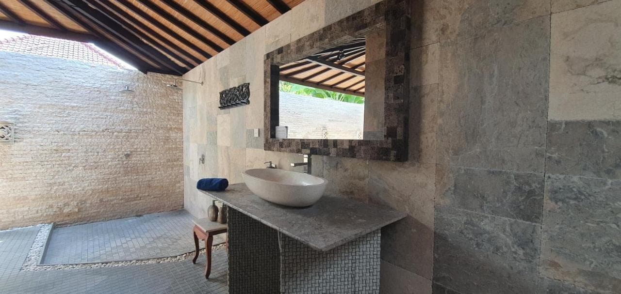 a bathroom with a sink and a window at Coral View Villas in Amed