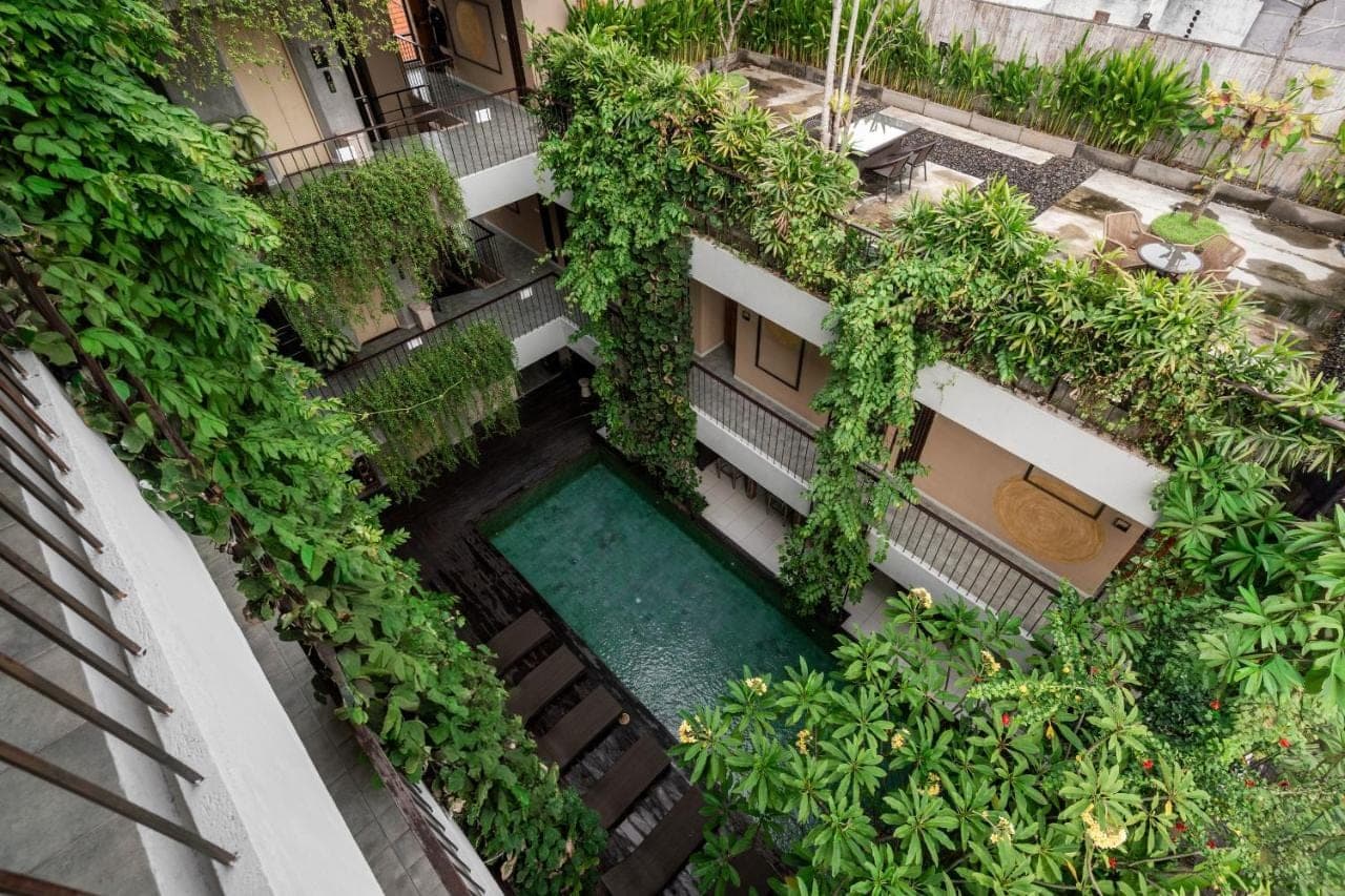 an overhead view of a building with a swimming pool at Tanaga CoLiving in Seminyak
