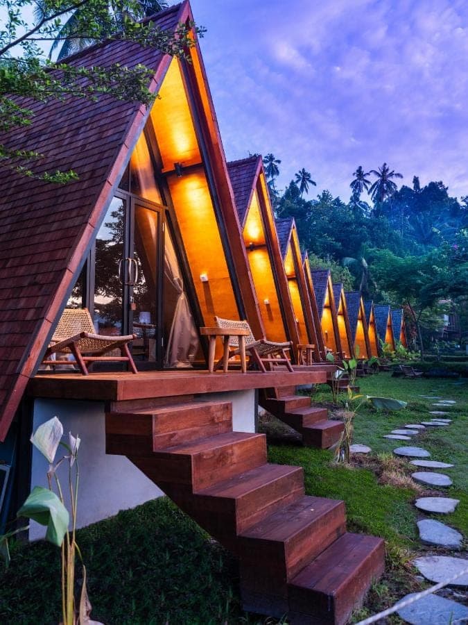 a row of tiny houses on a resort with stairs at Natya River Sidemen in Sidemen