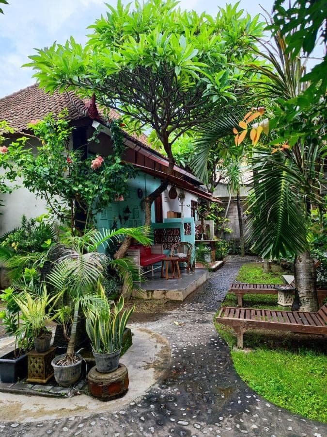 a house with trees and plants in front of it at Dalum Homestay in Amed