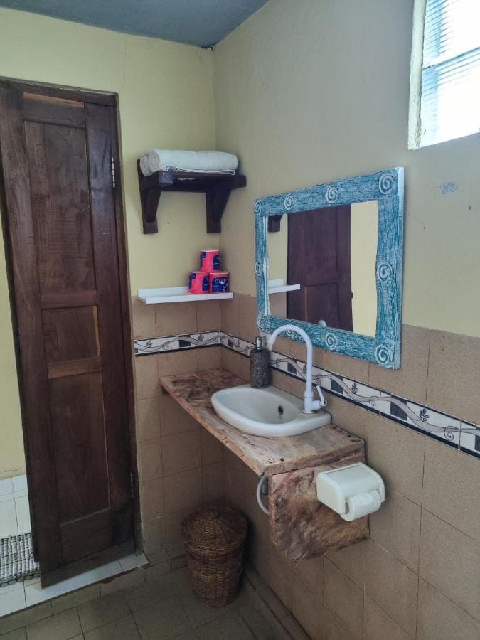 a bathroom with a sink and a mirror at Dalum Homestay in Amed