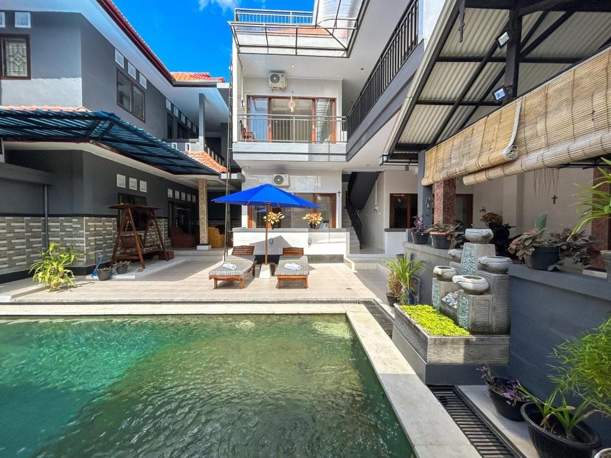 a swimming pool in the middle of a house at James Guest House in Seminyak
