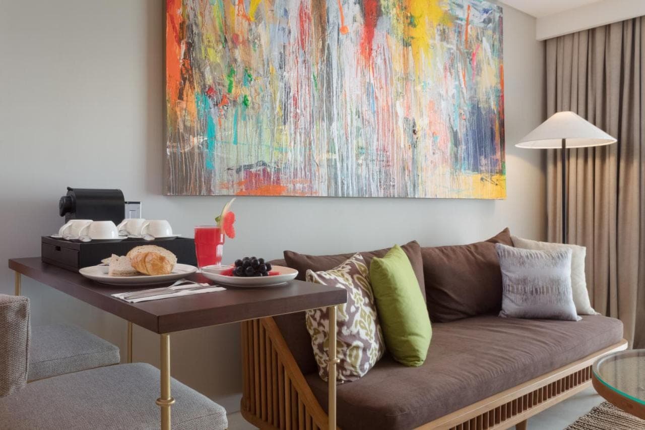 a living room with a couch and a table at Beachwalk Residence in Kuta