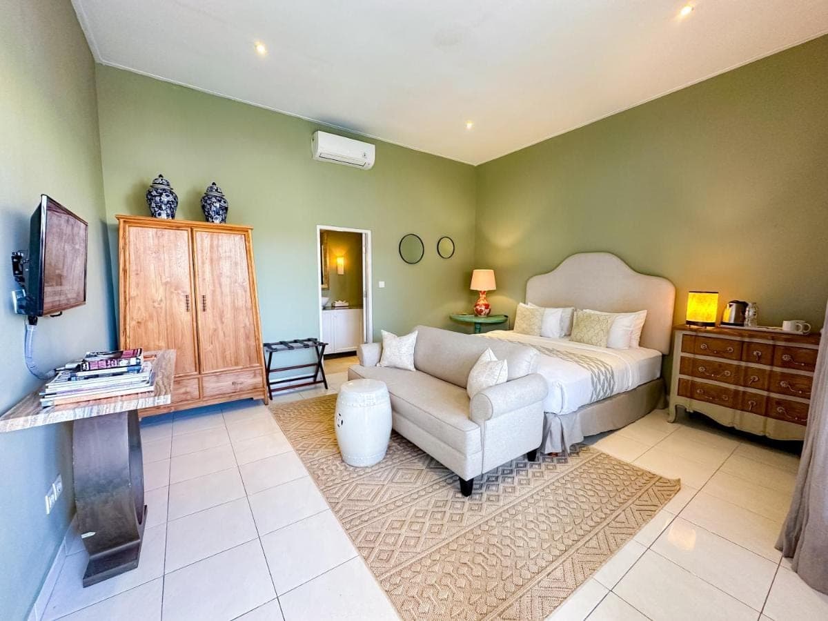 a living room with a couch and a bed at Room Sweet Room - Seminyak Center, walk to the Beach in Seminyak
