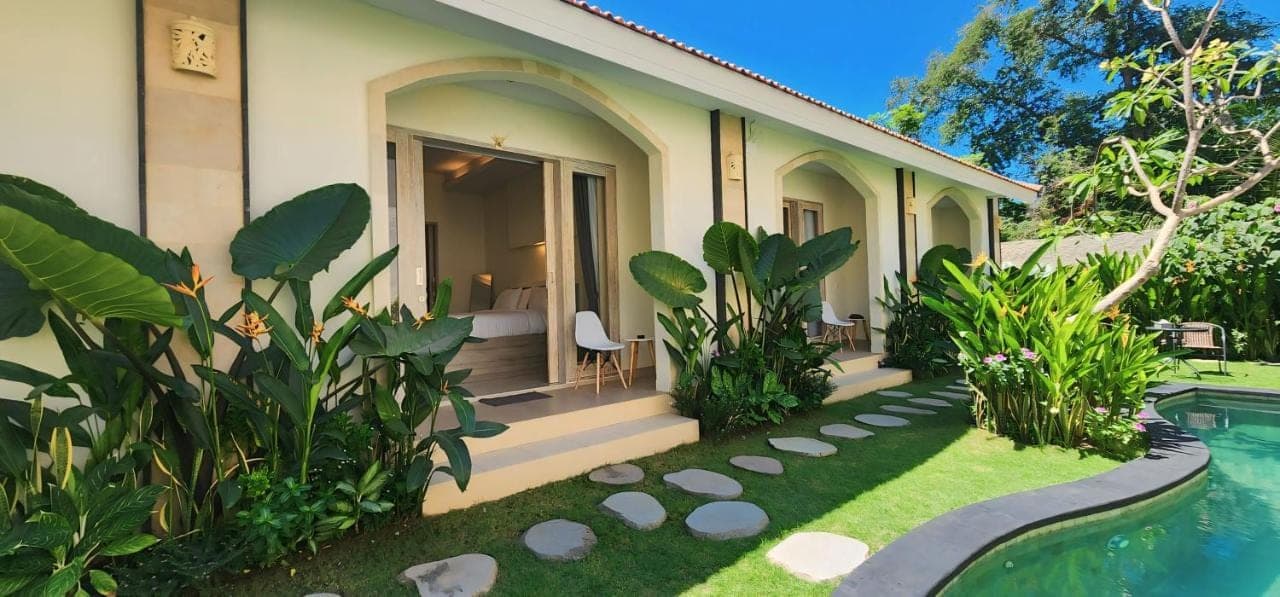a house with a swimming pool in front of it at D'Leafy Seminyak in Seminyak
