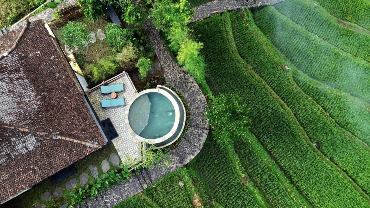 an overhead view of a swimming pool in a field at Abian Ayu Villa in Sidemen
