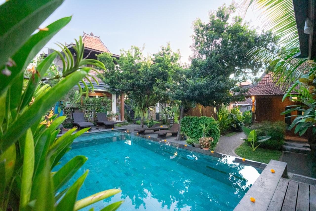 a swimming pool in the backyard of a house at Arana Garden Ubud in Ubud