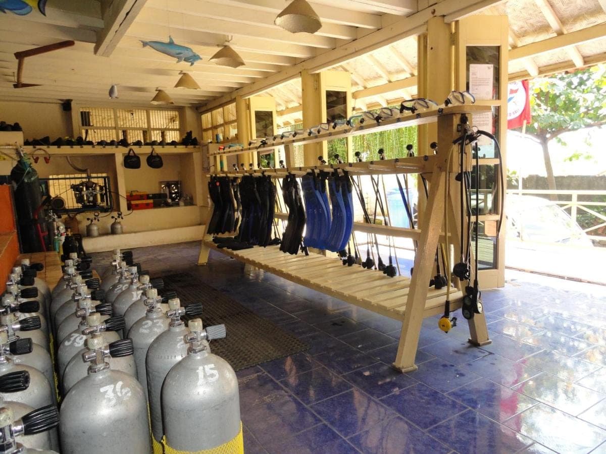 a room with a bunch of empty bottles on display at Jukung Dive Resort Bali AMED in Amed