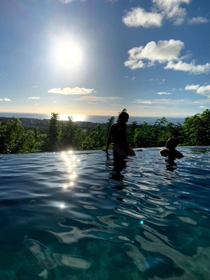 a group of people standing in the water at OCEANNA - Uluwatu, Bali in Uluwatu
