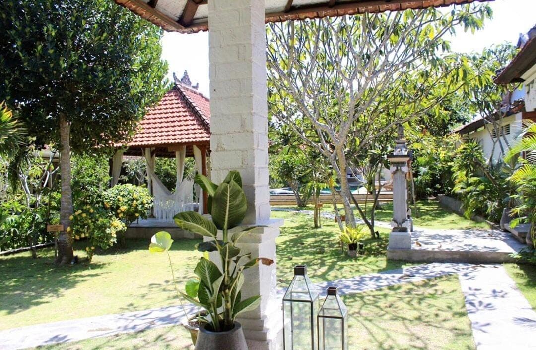 a garden with a gazebo and a plant at The Inn Possible in Uluwatu