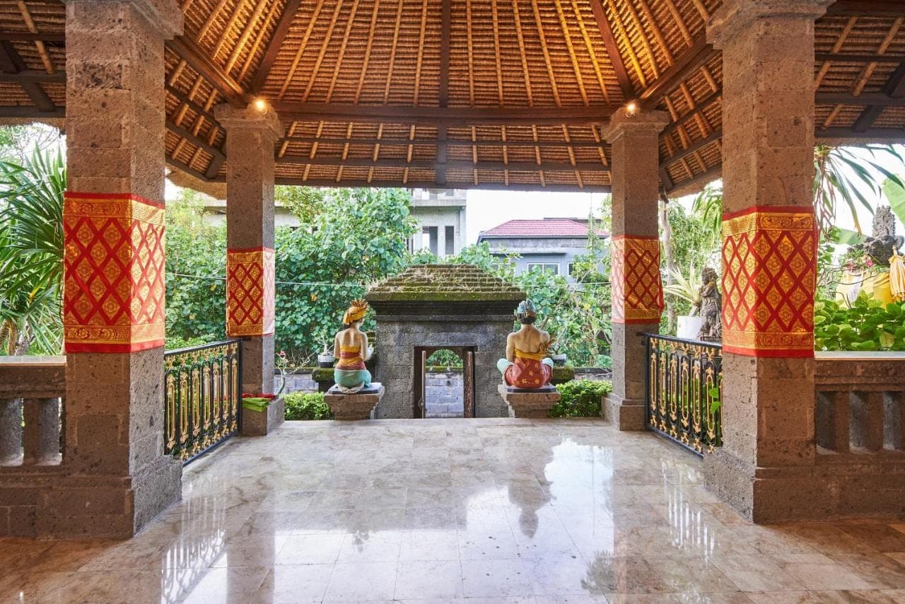 an outside view of a building with a large pavilion at Ellies Hotel in Nusa Dua