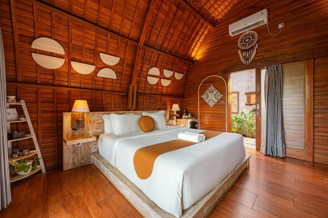 a bedroom with a bed in a wooden room at Cove Jiwana Villa in Nusa Dua