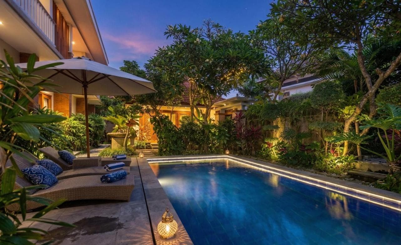 a swimming pool in the backyard of a house at Anindya Sanur in Sanur