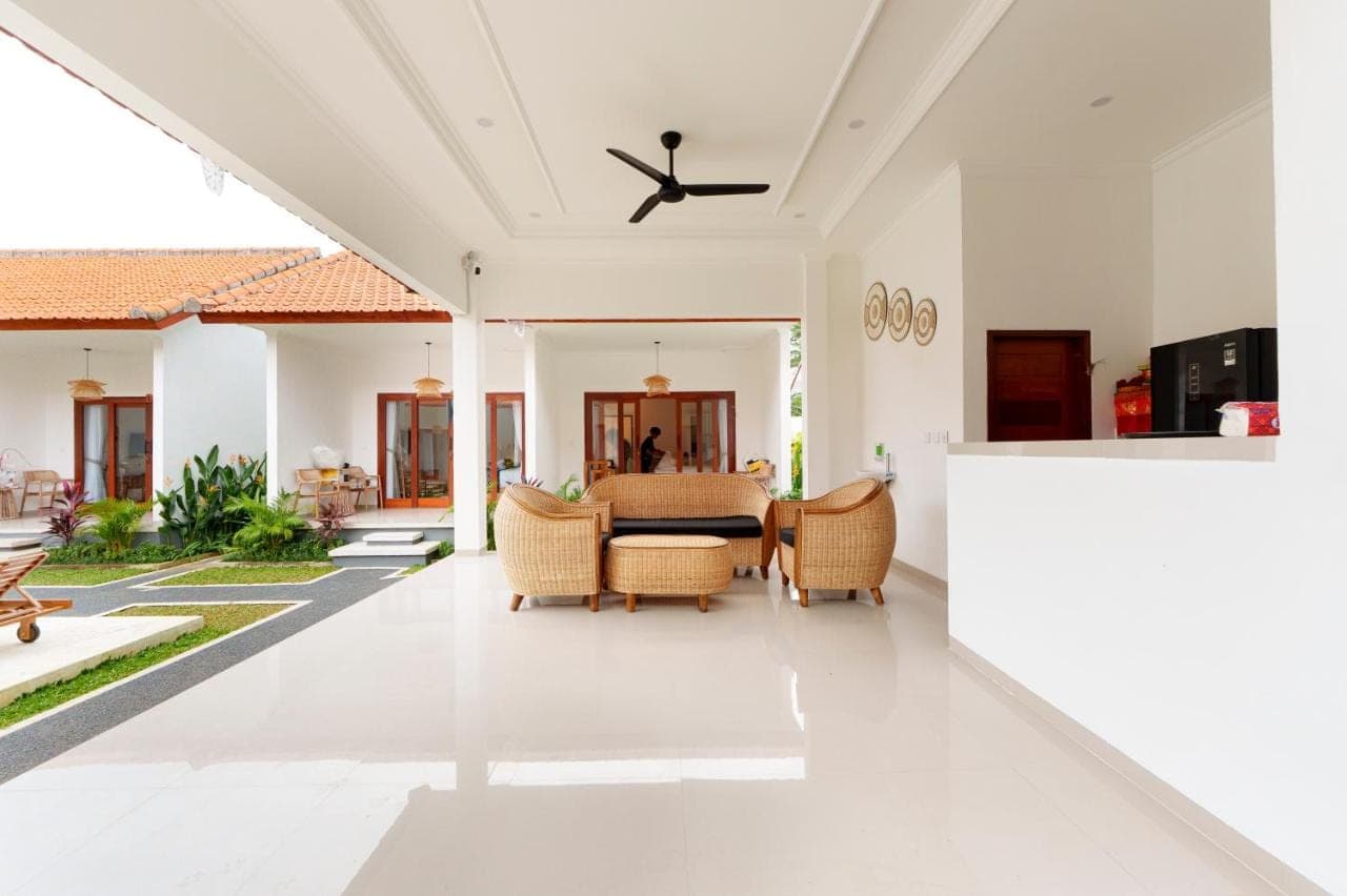 an open living room with a table and chairs at The Sanja Uluwatu in Uluwatu