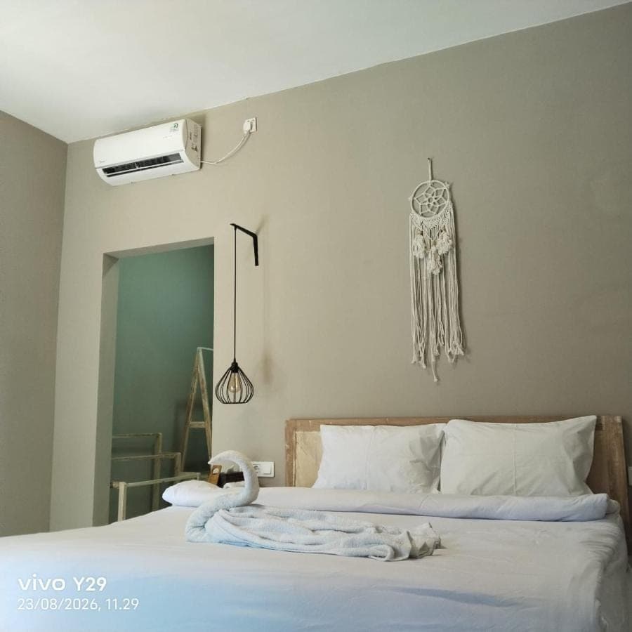 a bedroom with a bed with a towel on it at Langoon House in Uluwatu