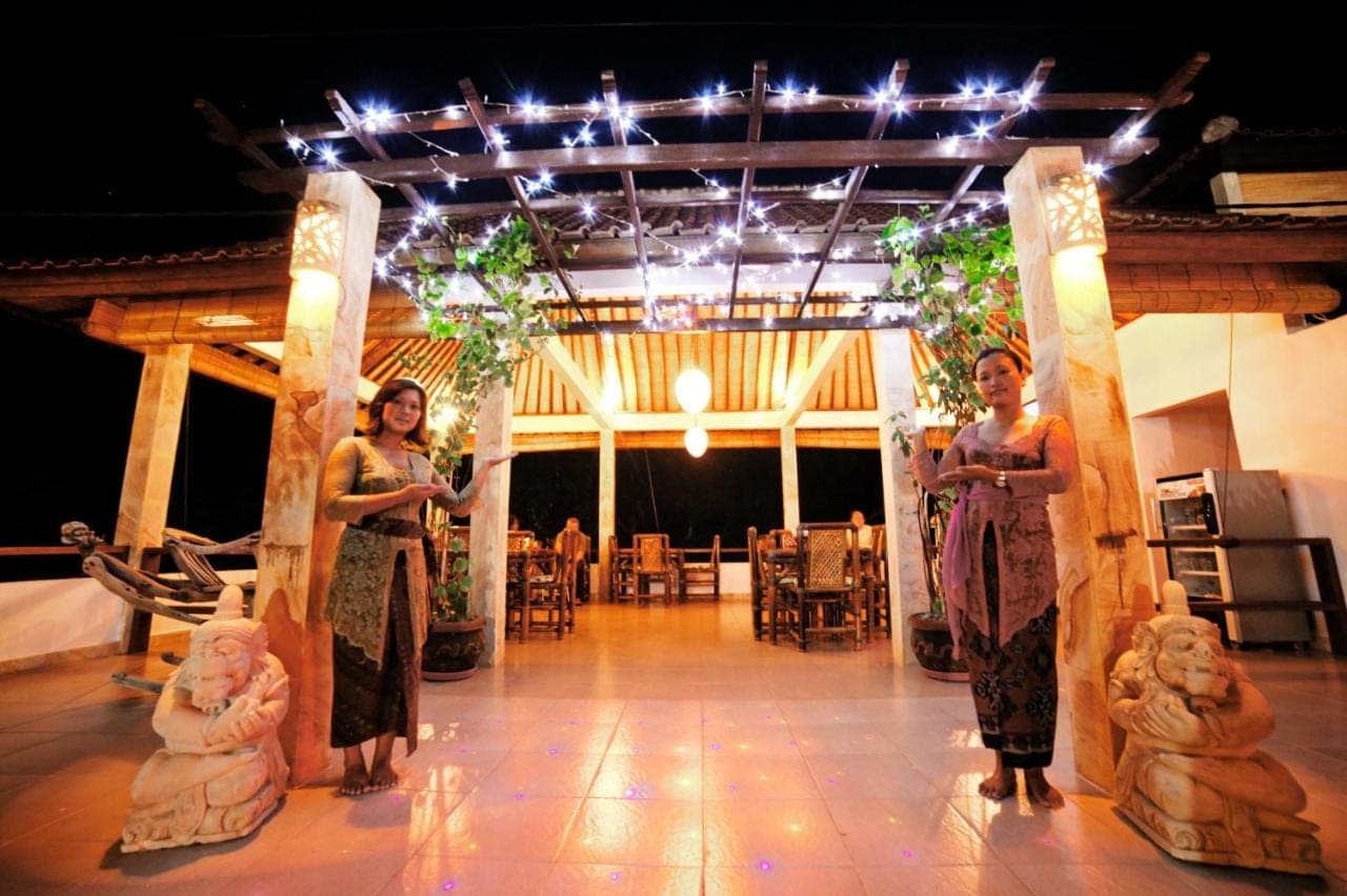 a group of women standing on a stage at Bali Dream House in Amed