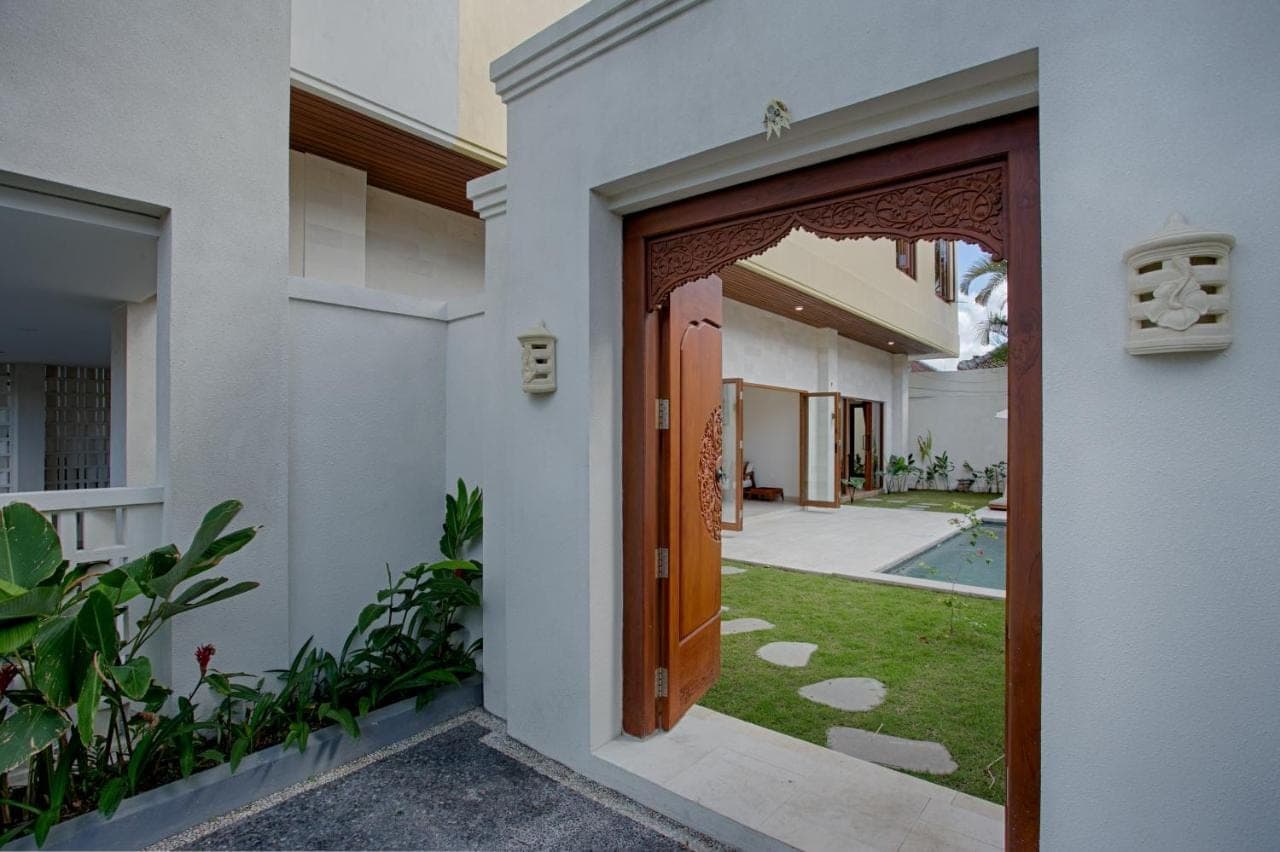 an open door of a house with a yard at My Villa and Resort Canggu in Canggu