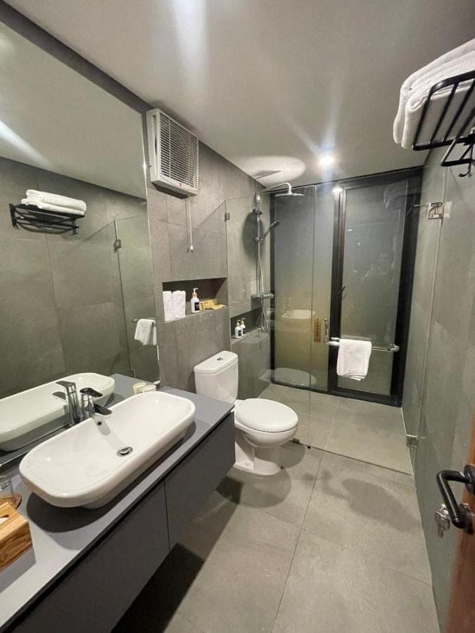 a bathroom with a white toilet and a sink at Widji Garden Villa in Uluwatu